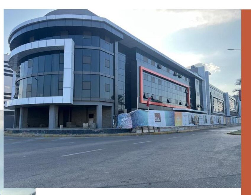 Construction photo: curved corner of Building A, structure and facade complete.